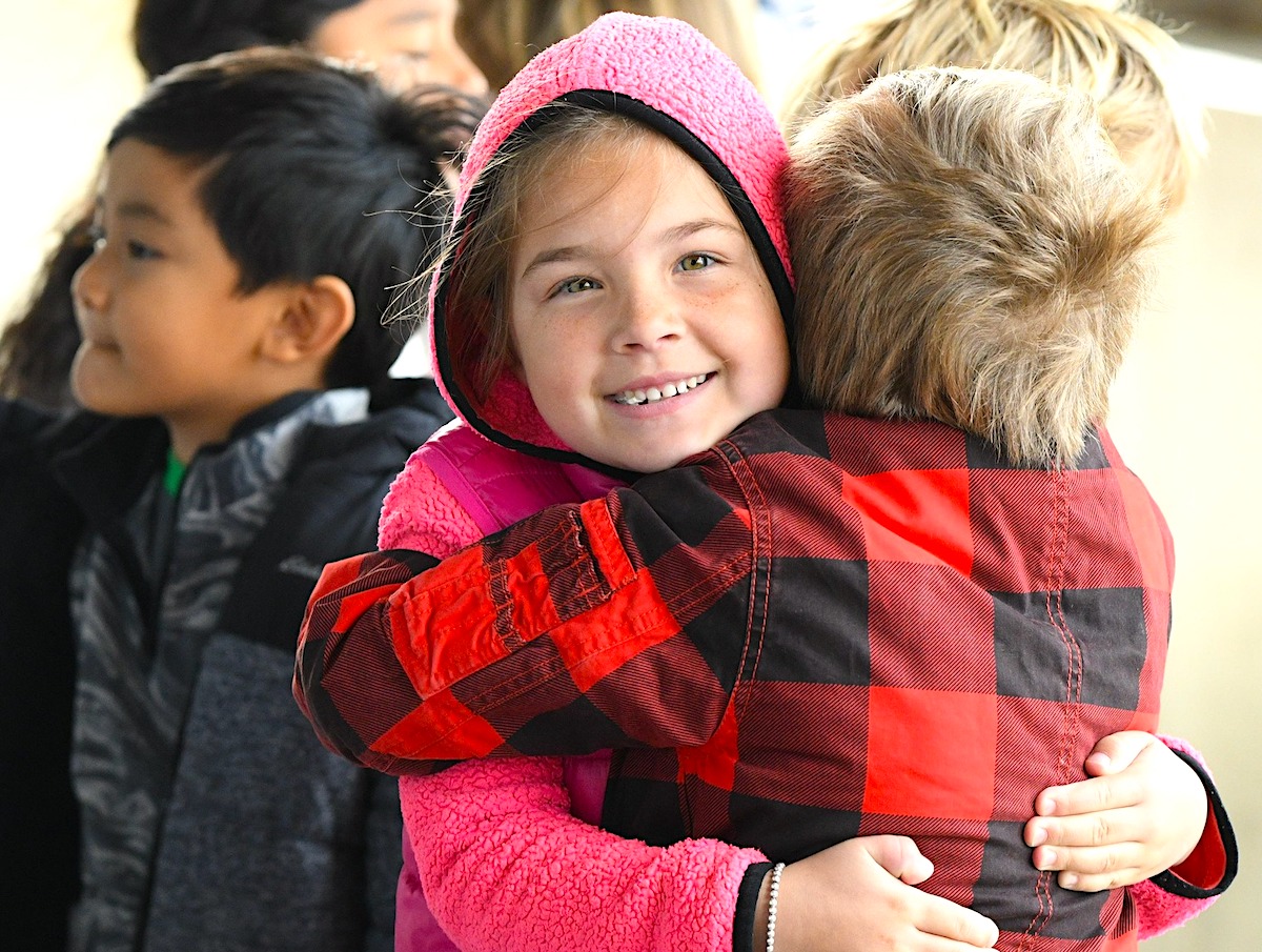 two San Diego tuition-free TK-8 charter school students hugging each other on the playground