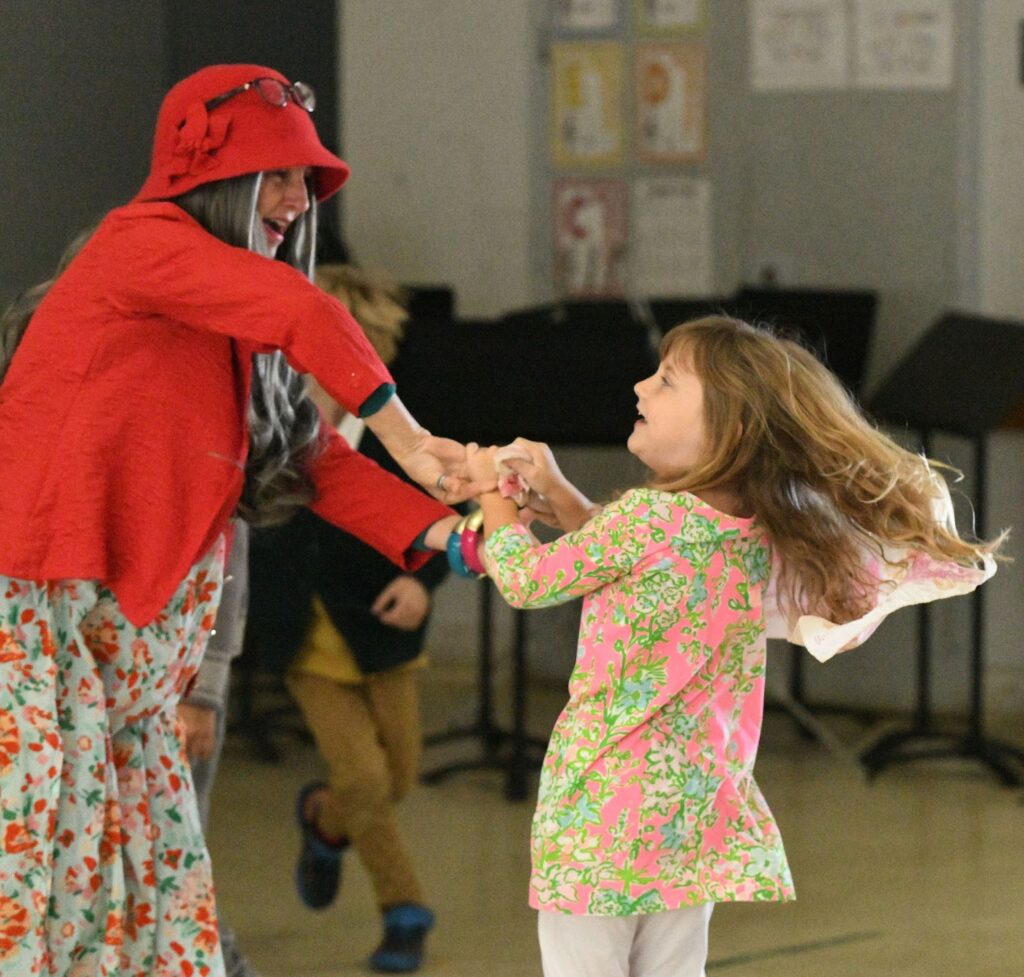 Student and teacher at San Diego TK-8 tuition free charter school dancing together.